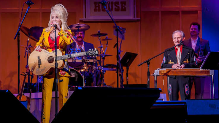 Don Warden playing pedal steel behind Dolly Parton onstage